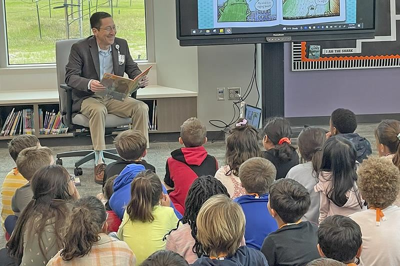 Roy Garcia, CFISD chief academic officer, reads to McGown Elementary School third grade students.